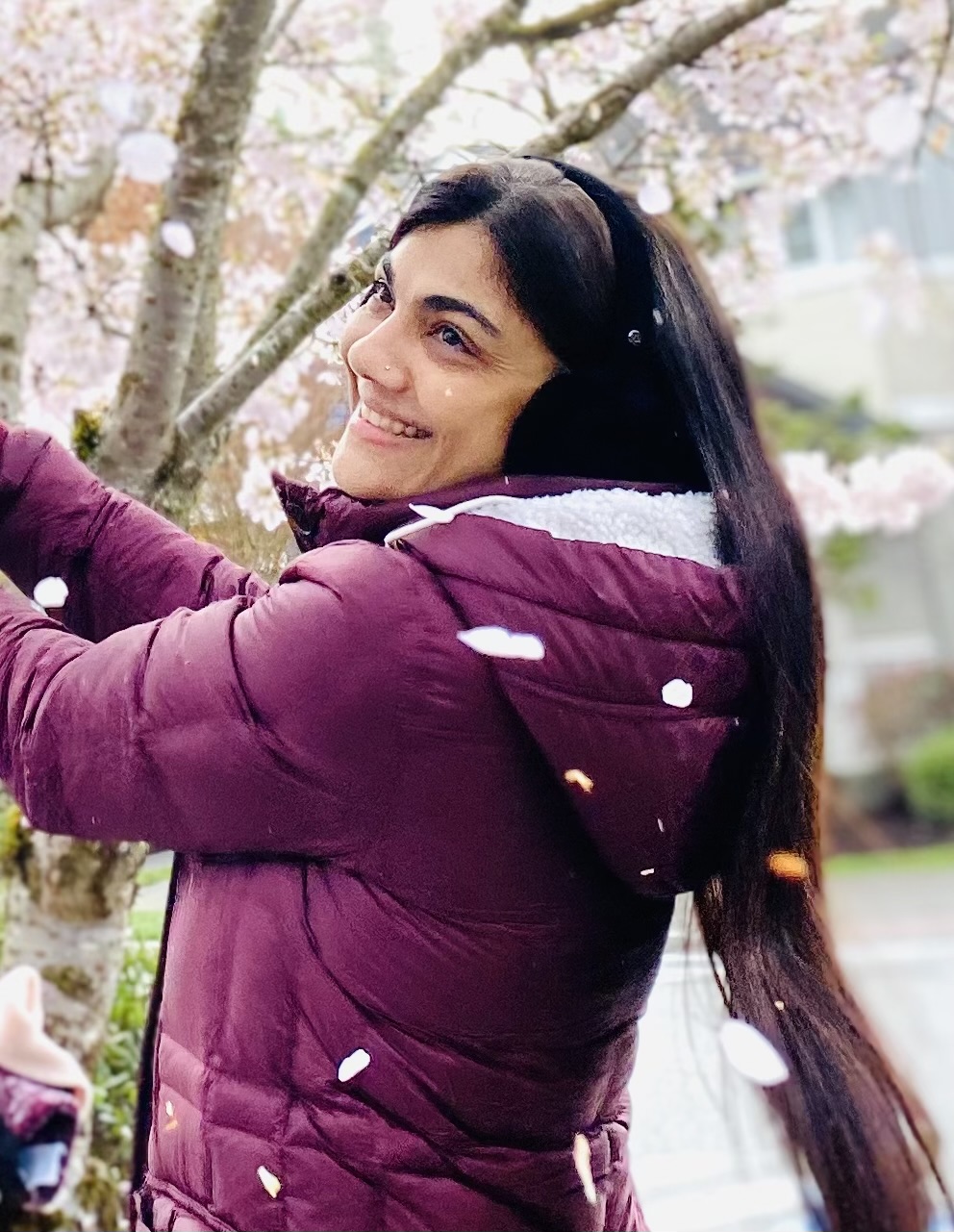 Avani Vimawala beside a cherry-blossom tree